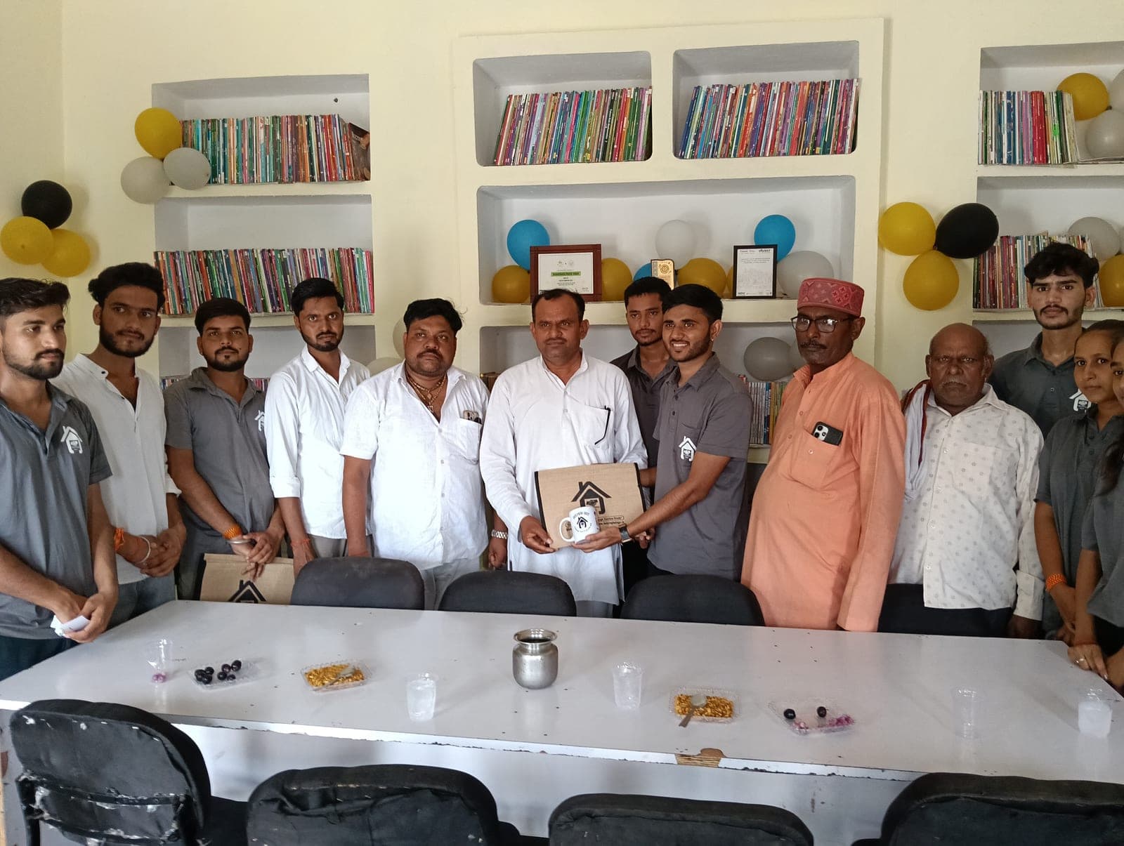 Village elders and guests being felicitated inside the GyanKutir library