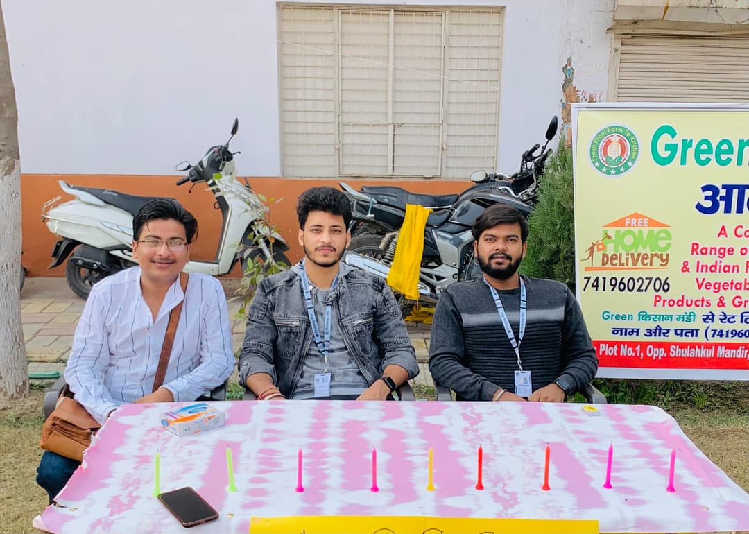 Three Helping Hut volunteers at the carnival registration table